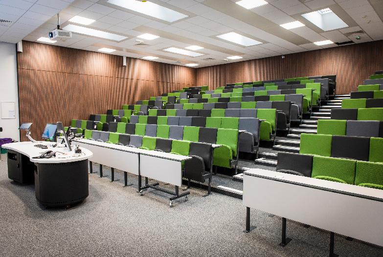 Photo of Lecture Theatre 1, a large lecture theatre with tiered green seating
