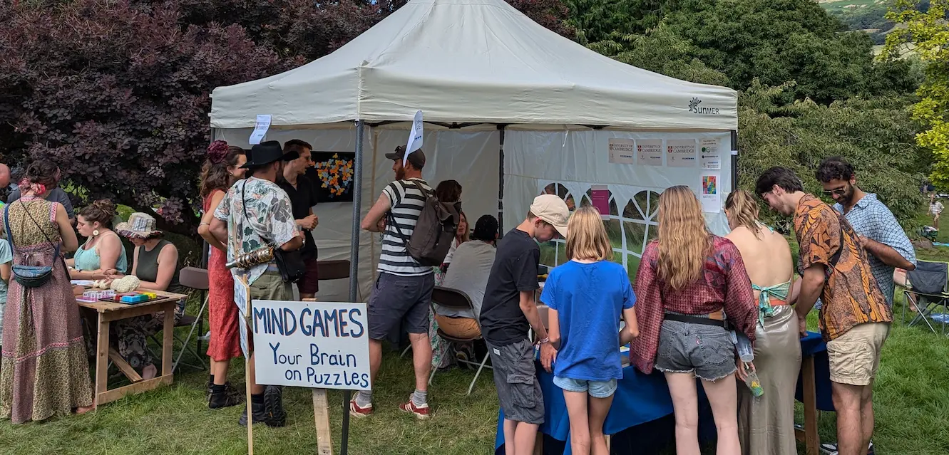 Photo of a stall at a festival, with a sign that says